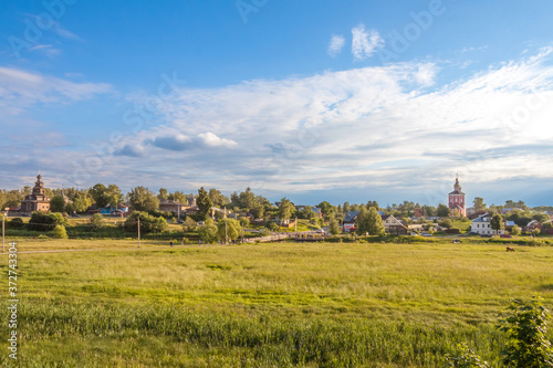 Rural landscape, field, houses and Church into the distance, Suzdal, Golden Ring, Russia
