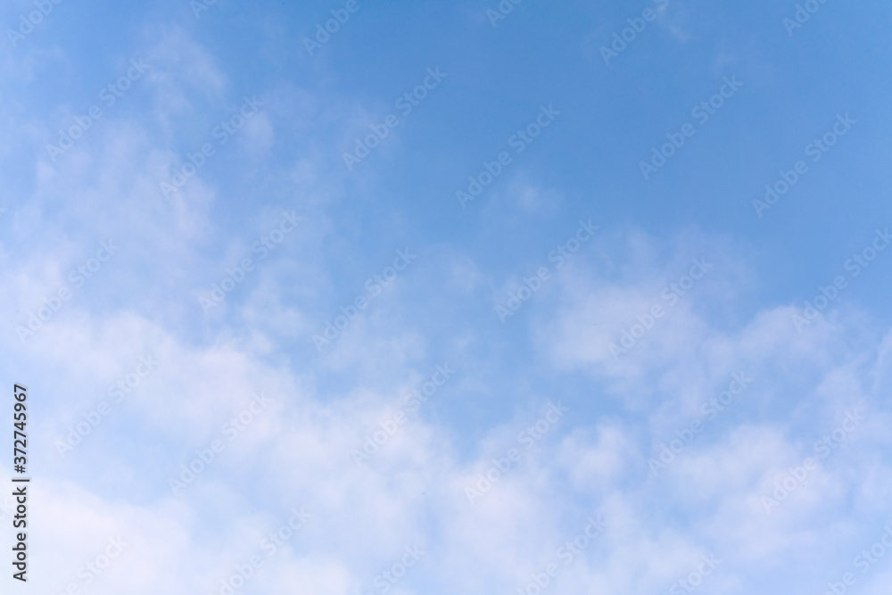 White cumulus clouds against the background against blue on a blue background. White cumulus clouds against the background against blue on a blue background.