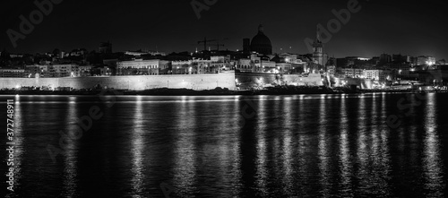 View over the Valletta city from Marsans Harbour in night, monochromatic