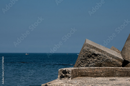 The Cantabrian sea and blocks of rock in a fishing village. photo