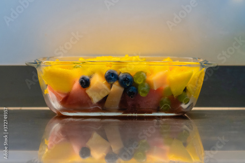 glass bowl with fresh fruits salad