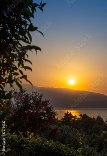 Sunrise in Manerba del Garda with the silhouettes of the mountains in the background on Lake Garda  Italy