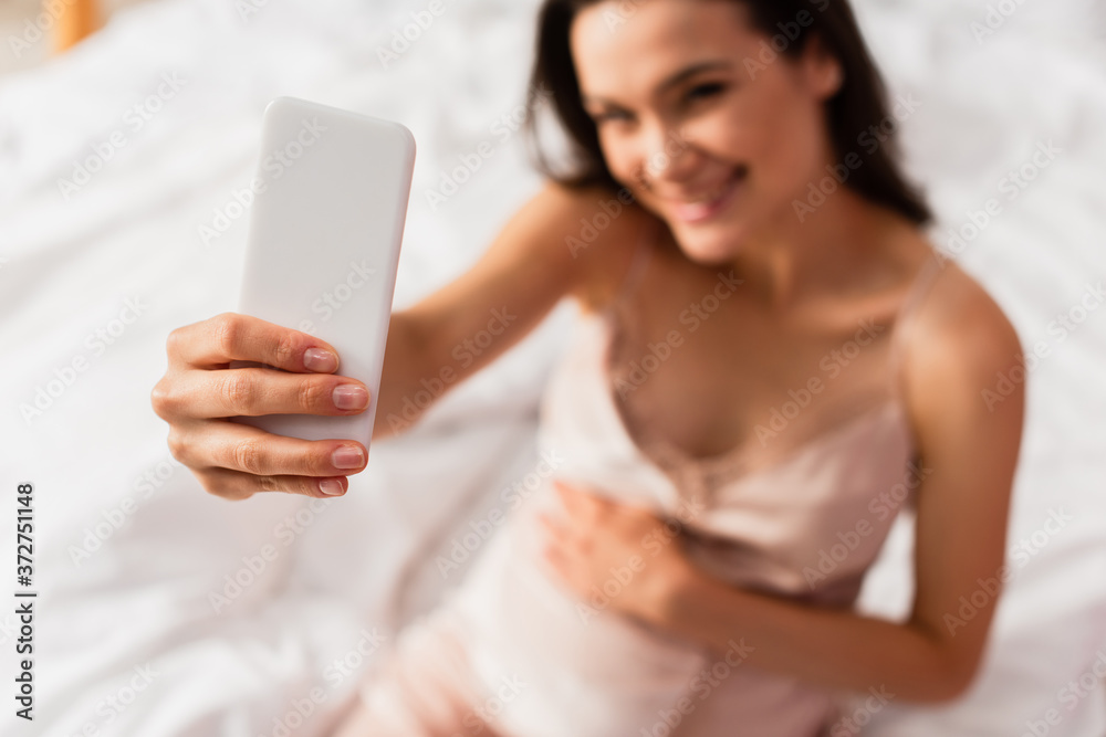 selective focus of pregnant woman taking selfie in bedroom selective focus of pregnant woman taking selfie in bedroom