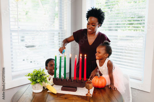 Black mother lighting kwanza candles  photo