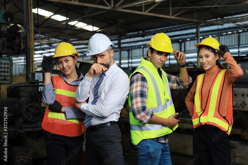 Portrait of engineering group in factory, Engineering and manager in warehouse Portrait of engineering group in factory, Engineering and manager in warehouse
