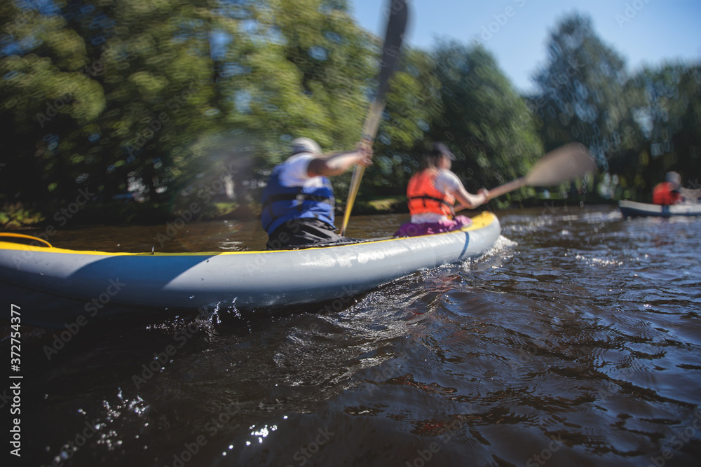 Naklejka premium A process of kayaking in the city river canals, with colorful canoe kayak boat paddling, process of canoeing, group of kayaks