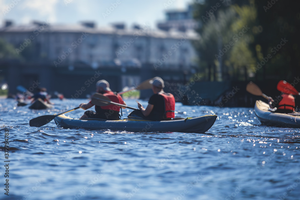 A process of kayaking in the city river canals, with colorful canoe