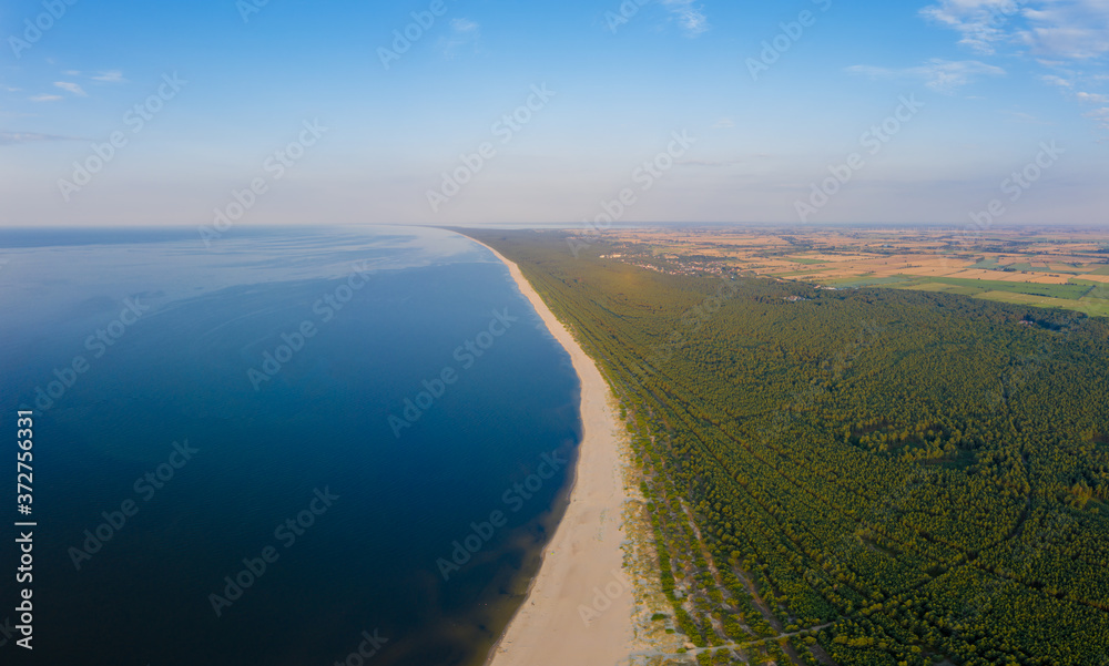 Fototapeta Aerial view  transparent turquoise sea in Baltic Sea.Summer seascapel, beach, beautiful waves, blue water at sunset. Top view from drone