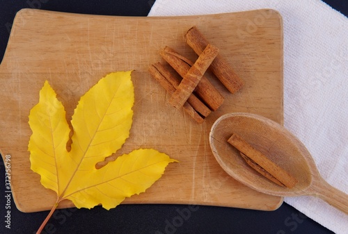 Cinnamon sticks on wooden board.
