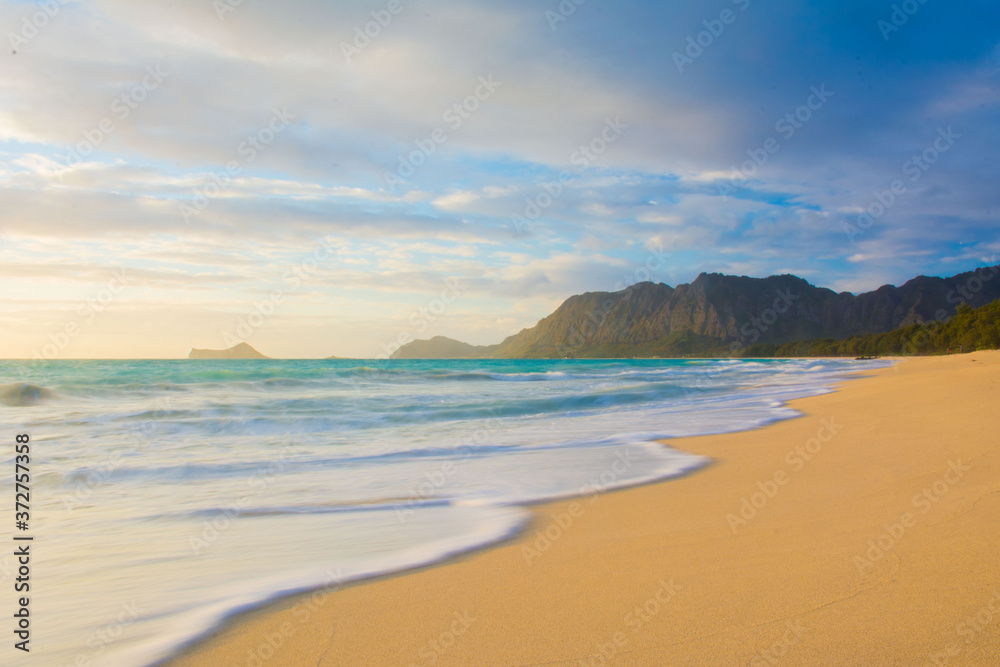 Coastline with waves at sunrise on the beach at Waimanalo on the windward side of Oahu in Hawaii