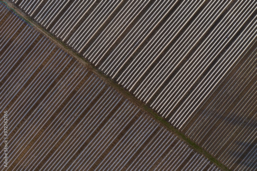 Top view of the beds and greenhouses. Diagonal lines.Farm fields Top view of the beds and greenhouses. Diagonal lines.Farm fields