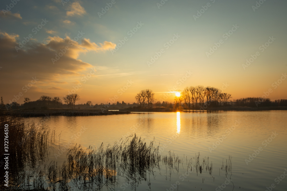 A beautiful sunset on a quiet lake with reeds A beautiful sunset on a quiet lake with reeds