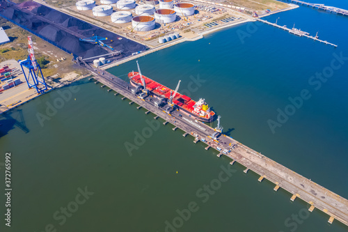 Container ship in import export and business logistic, By crane, Trade Port, Shipping cargo to harbor, Aerial view from drone, International transportation, Business logistics concept