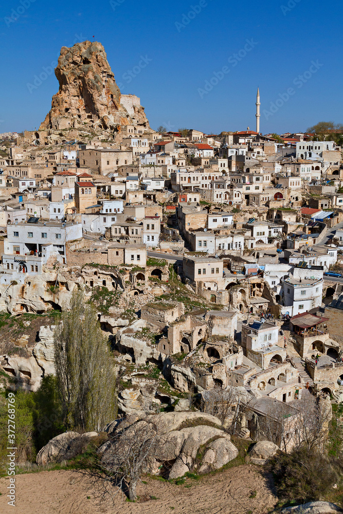 View over the ancient houses and cave dwellings in the town Ortahisar, Cappadocia, Turkey