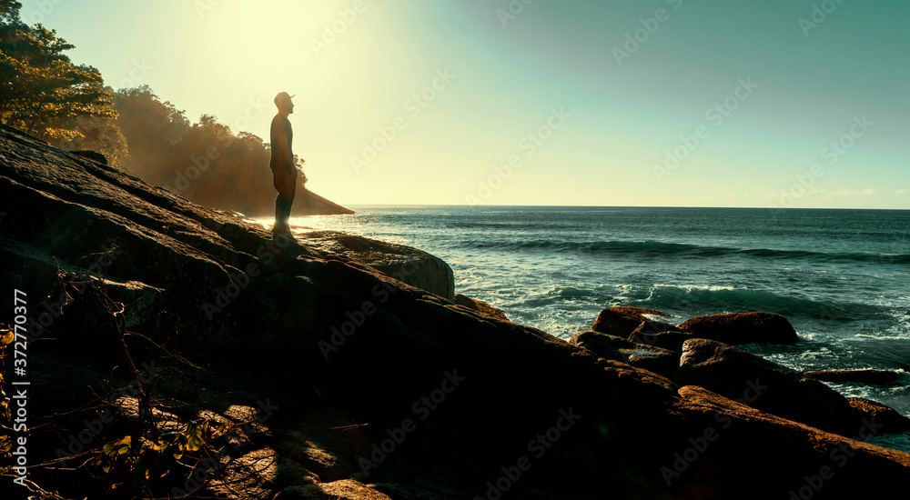 Man in sunset on the beach