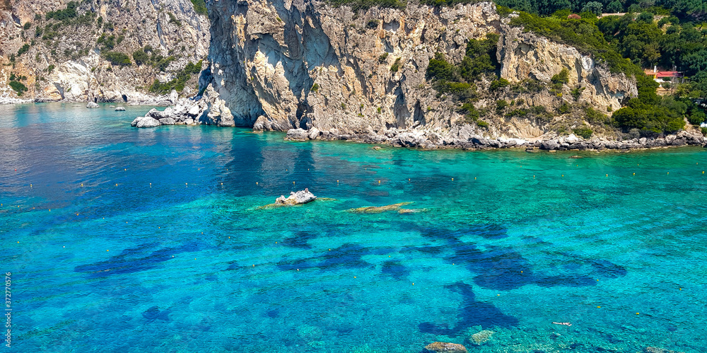 Shades of blue water in a rocky bay in Corfu, Greece