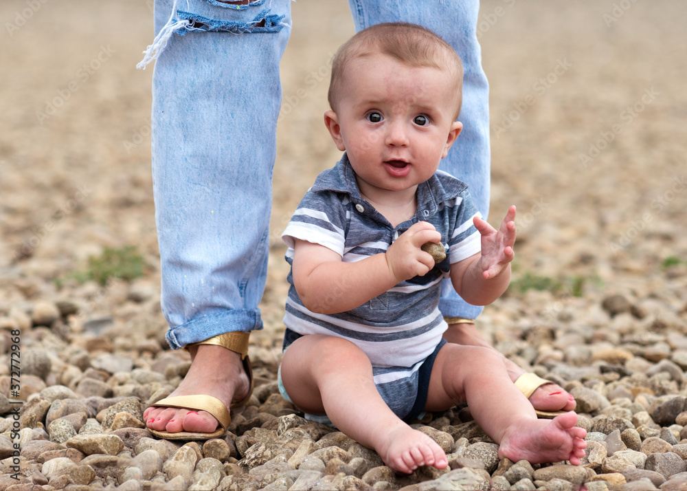 Small boy playng with stones on the seaside Small boy playng with stones on the seaside