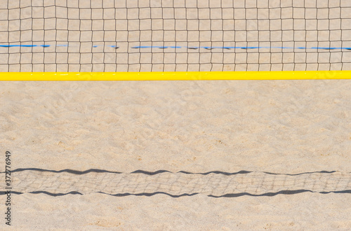 Volleyball net on the beach sand for background design. Sport team concept.