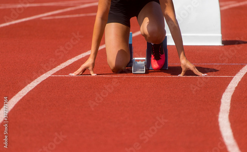 Runner in start position prepares for the start. Individual sport conept