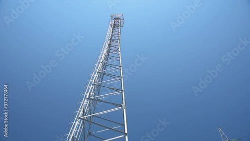 Communication tower at a frequency of 5G against a blue sky