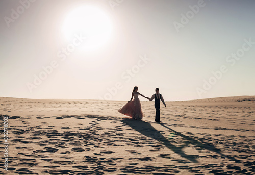 the bride and groom on the beach at sunset © Alisa