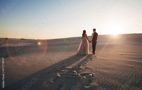 Photography newlyweds walk in the desert
