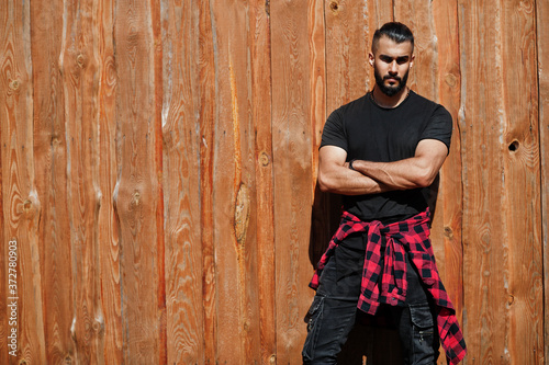 Arab hipster beard man lumberjack against wooden background.