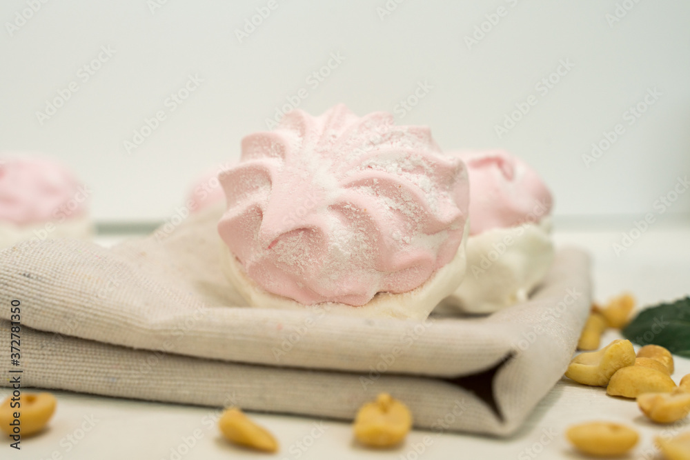 composition of delicate airy marshmallows and peanuts. low-calorie healthy sweets composition of delicate airy marshmallows and peanuts. low-calorie healthy sweets