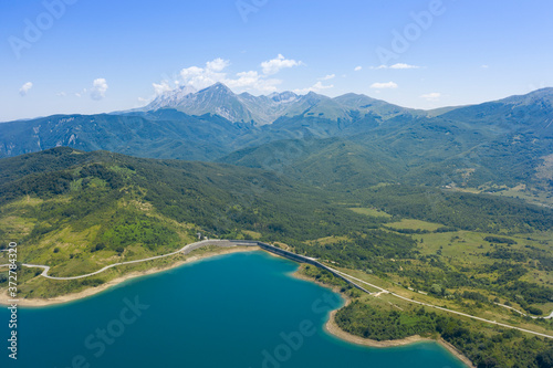 Fototapeta aerial view of lake campotosto and in the background the mountain area of gran s