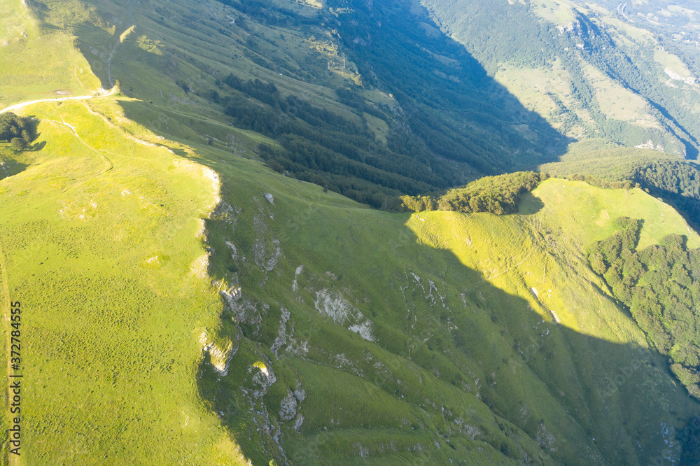 aerial view of a green grassland in the mountain area of Gran Sasso Italy