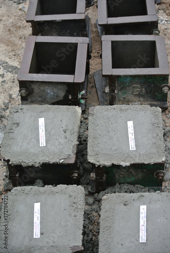 MALACCA, MALAYSIA -JUNE 18, 2016: Cube test. Steel mold in cube shape filled with concrete to get standard cube shape concrete block. The block will be used for compression test in laboratory. 