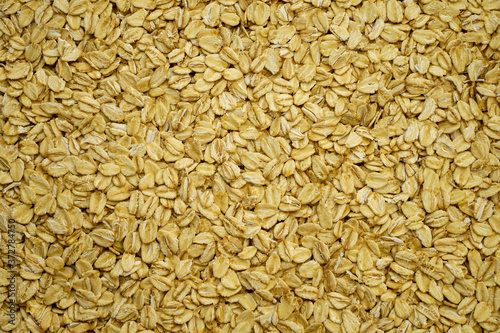Hercules, pure yellowish oat flakes as background