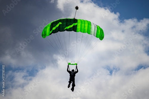 Skydiver with green parachute