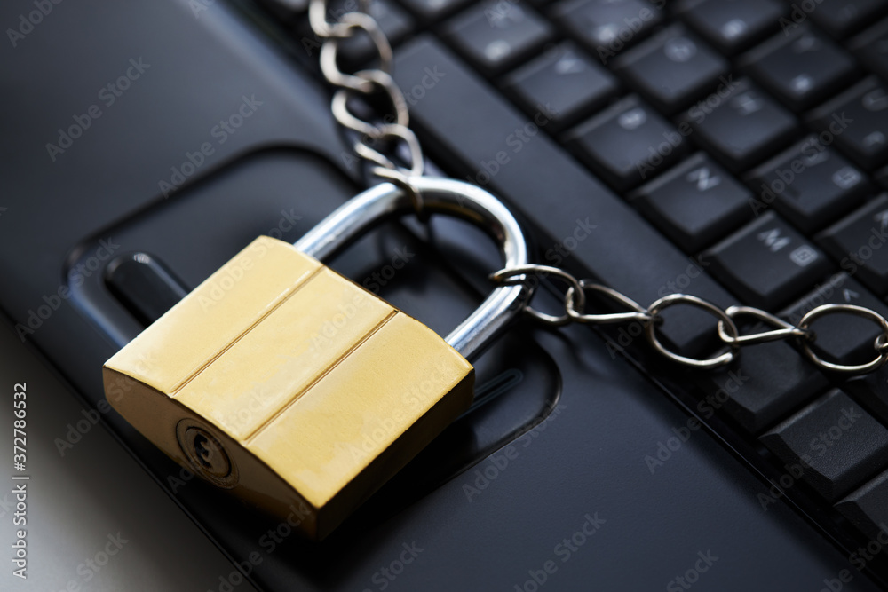 golden padlock on a black laptop keyboard over white background. internet security concept. antivirus software concept. electronic wallet symbol golden padlock on a black laptop keyboard over white background. internet security concept. antivirus software concept. electronic wallet symbol