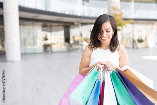 Smiling Woman With Bags At Shopping Center