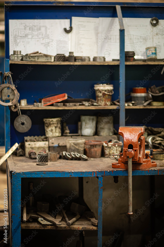 a workbench with tools in an old factory, a worker's Desk a workbench with tools in an old factory, a worker's Desk