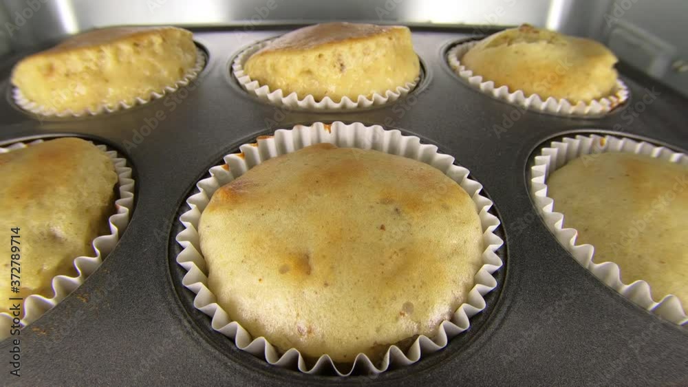 Macro time lapse view of banana nut muffins cooking in oven. Macro time lapse view of banana nut muffins cooking in oven.