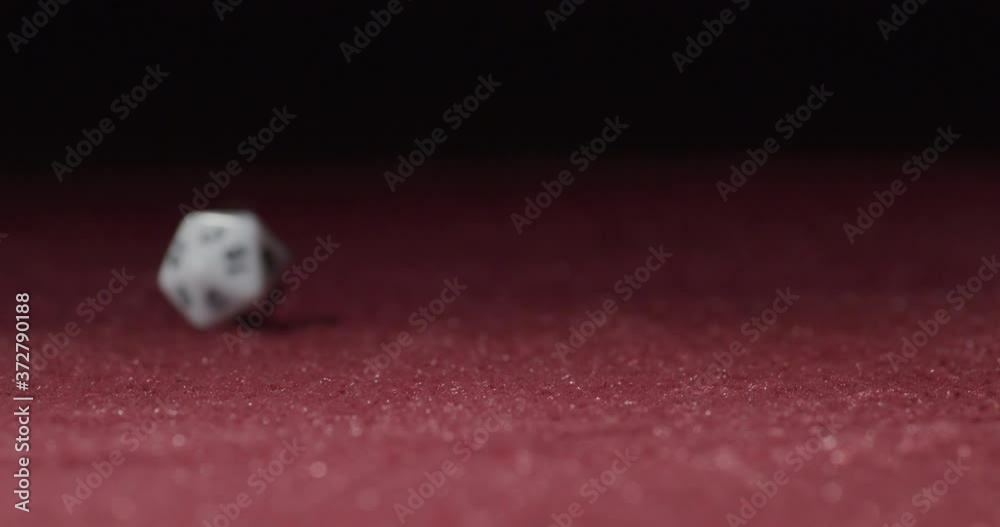Close-up of White 20-Sided Dice Rolling in Slow Motion Revealing 6 Side