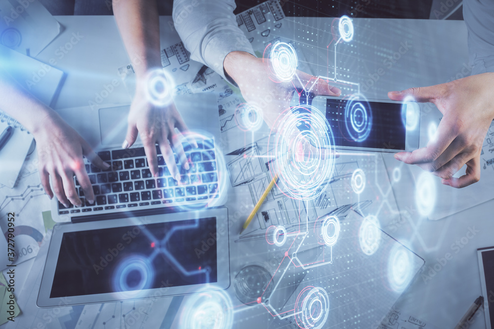 Double exposure of man and woman working together and data theme hologram drawing. Computer background. Top View.