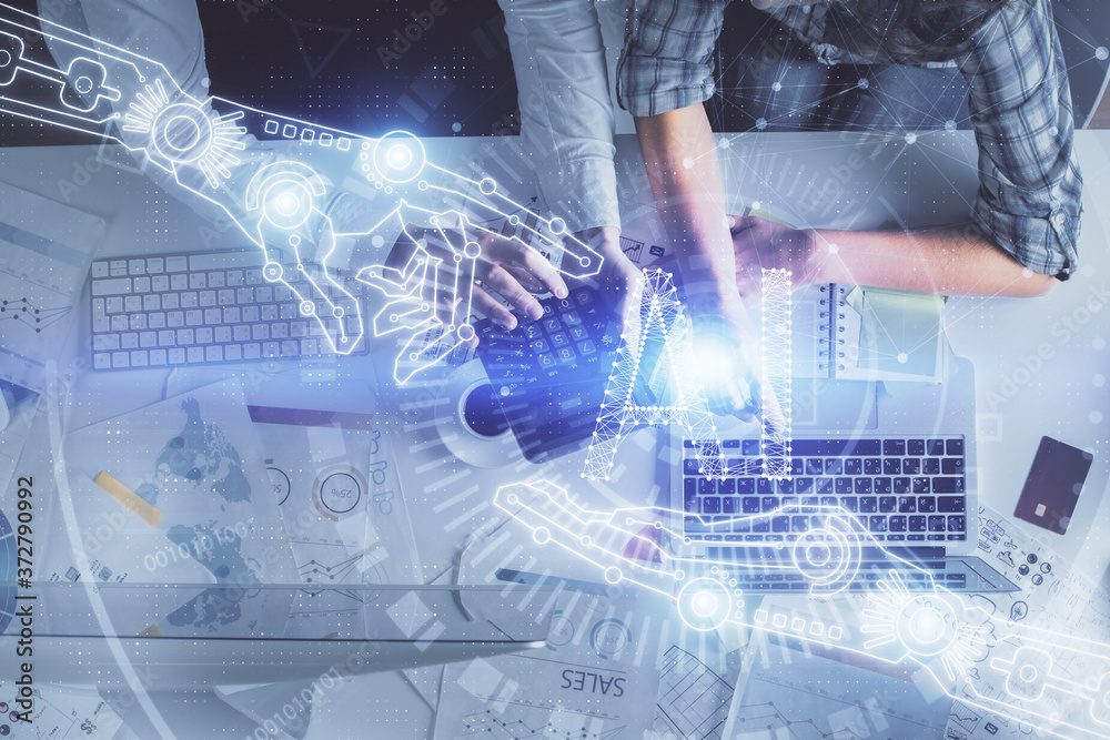 Double exposure of man and woman working together and data theme hologram drawing. Computer background. Top View. Double exposure of man and woman working together and data theme hologram drawing. Computer background. Top View.