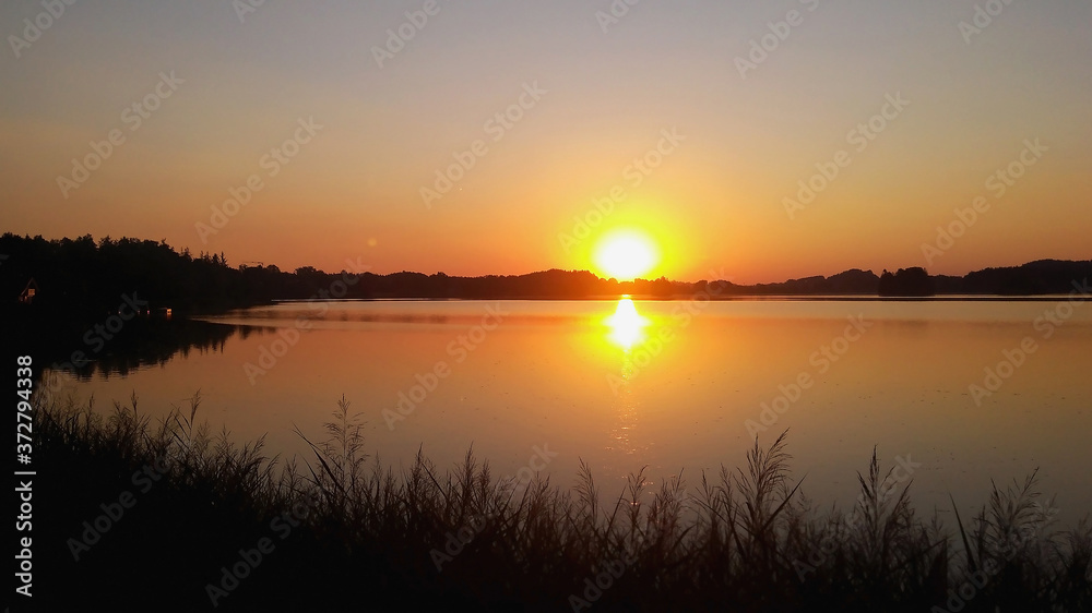 Sunset at Seehamer Lake in Germany. Reflection of the sun in the water at sunset. Sunset on a large lake. Euro-trip. Beautiful places in Germany.