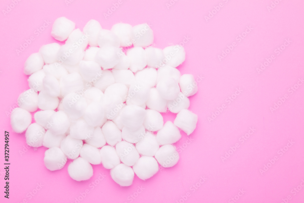 Top view pile of white cotton wool on pink Top view pile of white cotton wool on pink