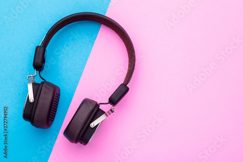 Black Headphone or Headset on bright color background. Copy space for text or design