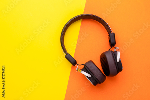 Black Headphone or Headset on bright color background. Copy space for text or design