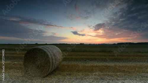 hay bales in the field at sunset - timelapse