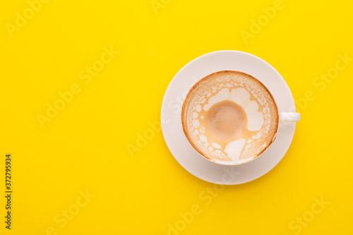 Empty white cup on yellow background. Copy space for text or design
