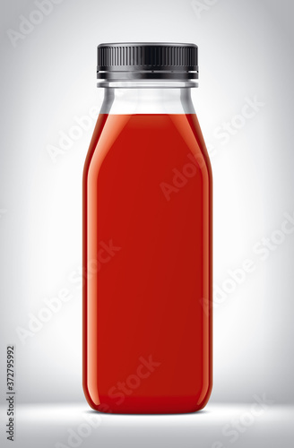 Plastic Bottle with tomatoes Juice on background. 