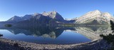 Wide Panoramic Early Morning Scenic Landscape View of Upper Kananaskis Lake with Distant Rocky Mountain Peaks in Kananaskis Country, Alberta Canada