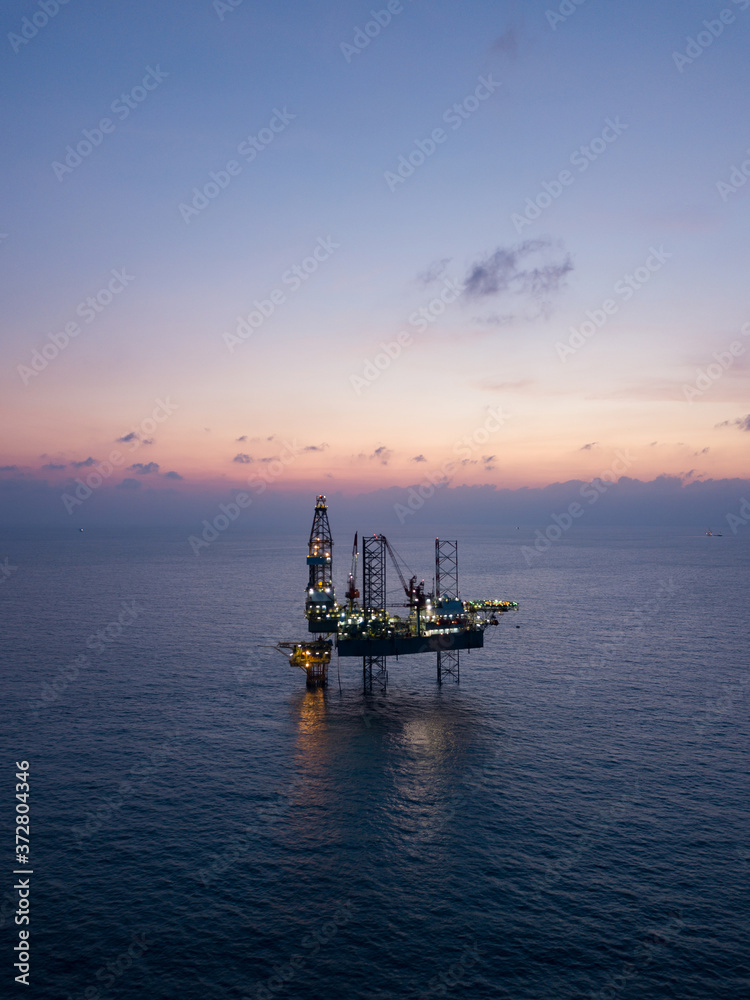 Aerial view offshore jack up rig at the offshore location during sunset