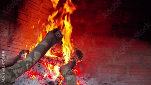 Slow motion of fire wood burning in traditional brick pizza oven 